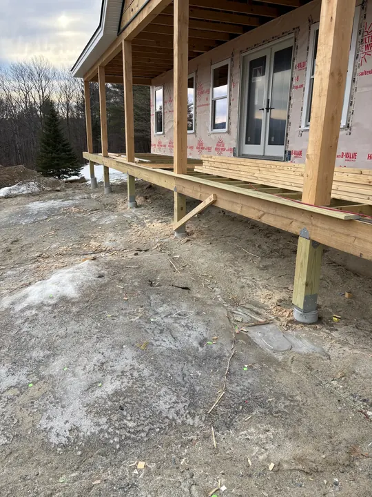 Posts and floor framing for a long covered porch on a new house