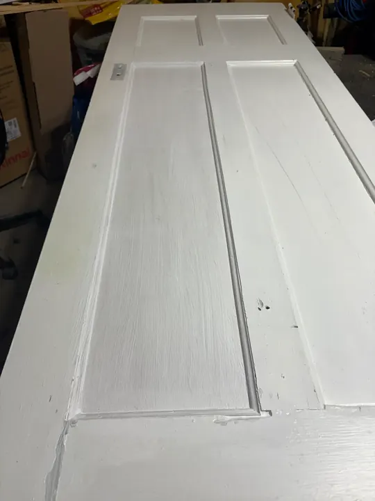 Restored door with the new panel filled, sanded and painted