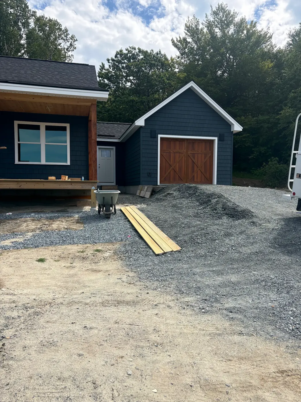 New garage with a wood-tone garage door matching the house