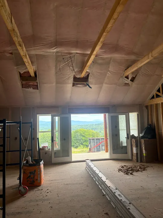 Ceiling insulation installed between exposed beams